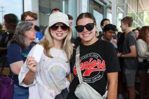two female students with a gift card